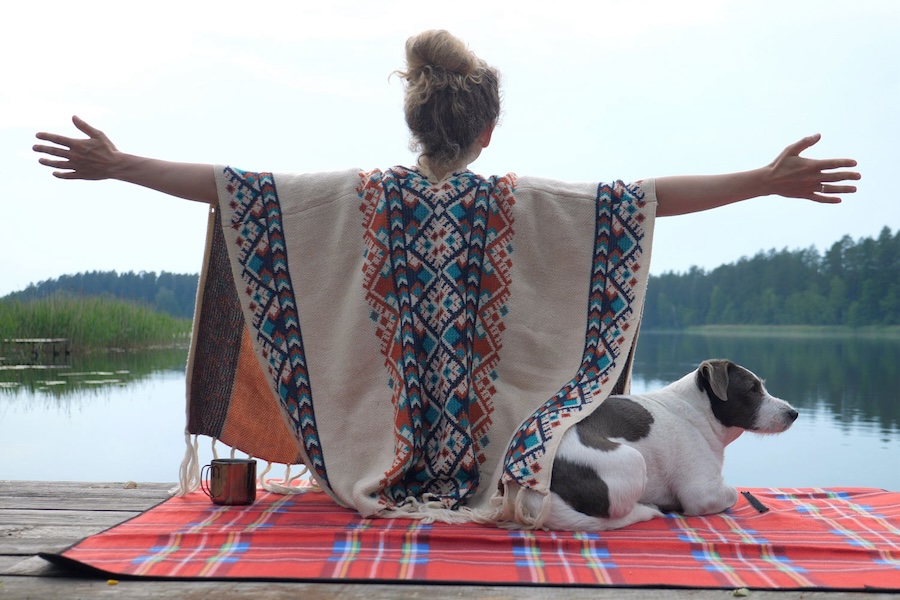 Image of a woman spreading her arms to a lake