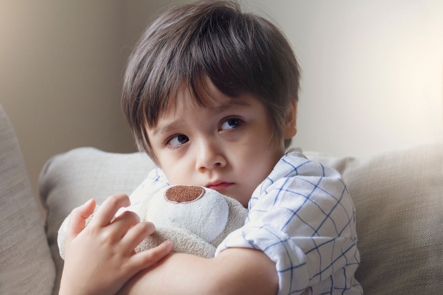 Image of a child upset holding a stuffed animal