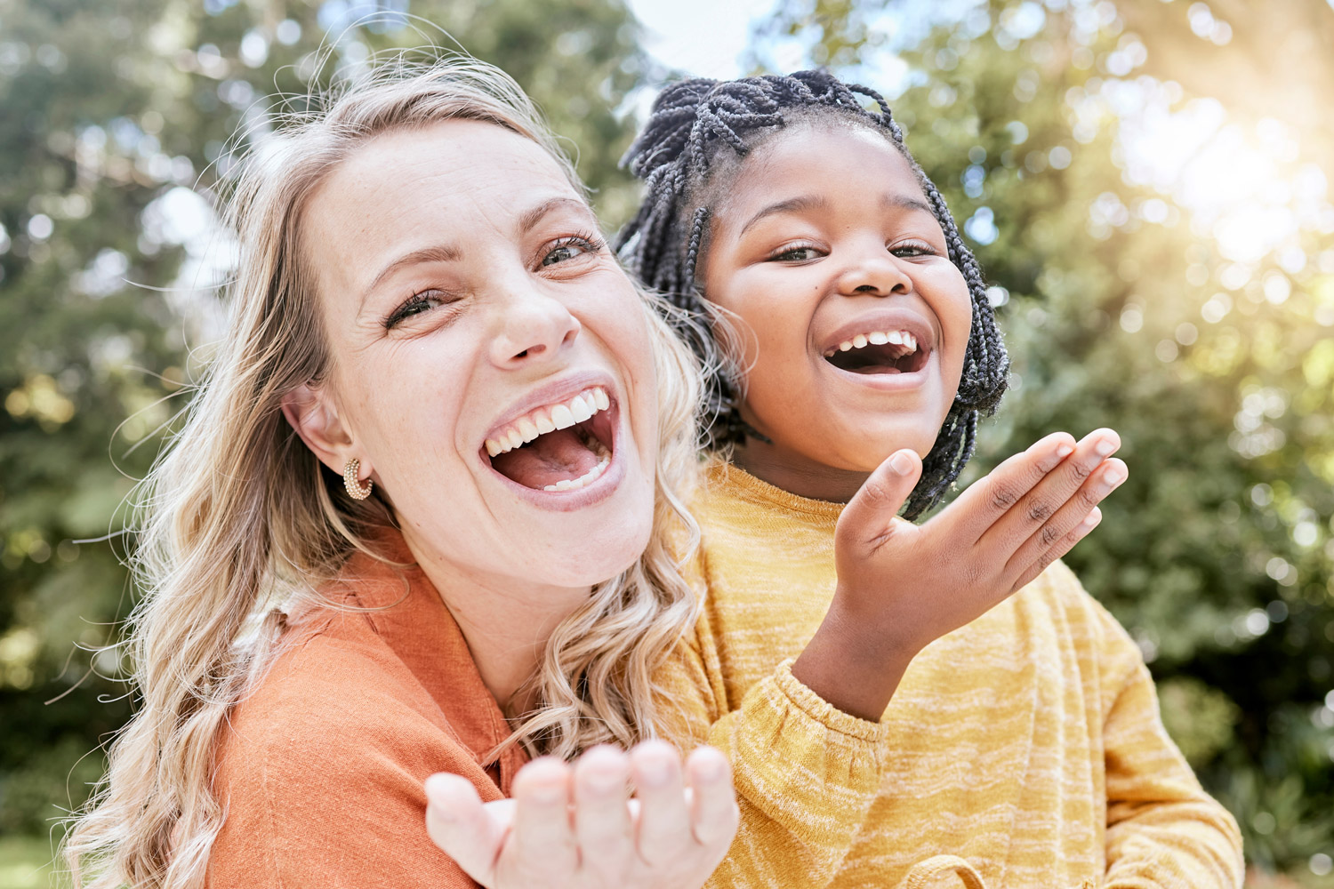 A woman and young girl smiliing