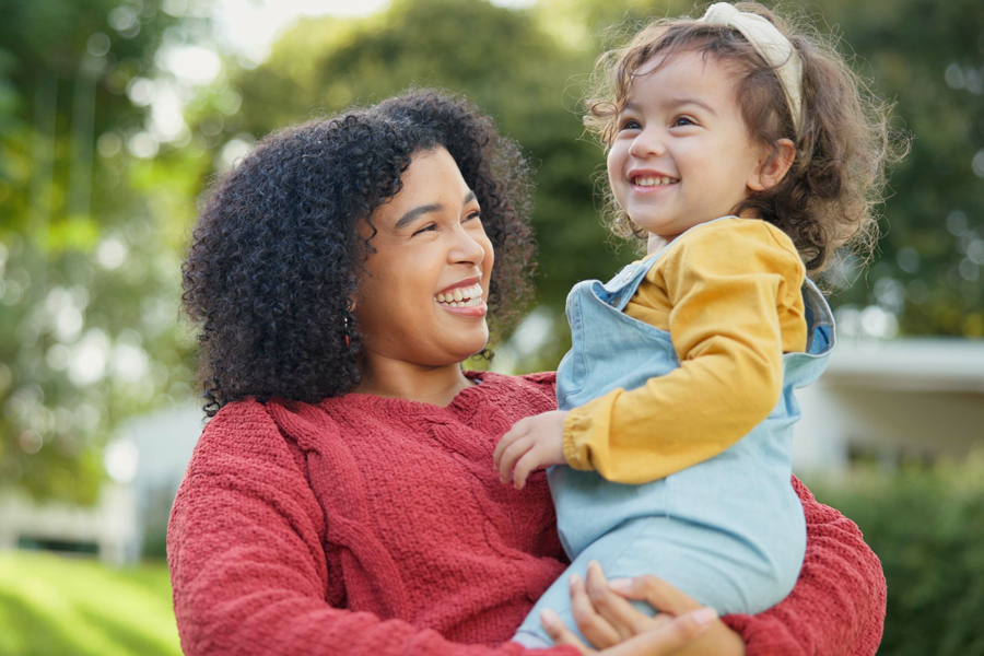 Mom holding daughter in her arms.