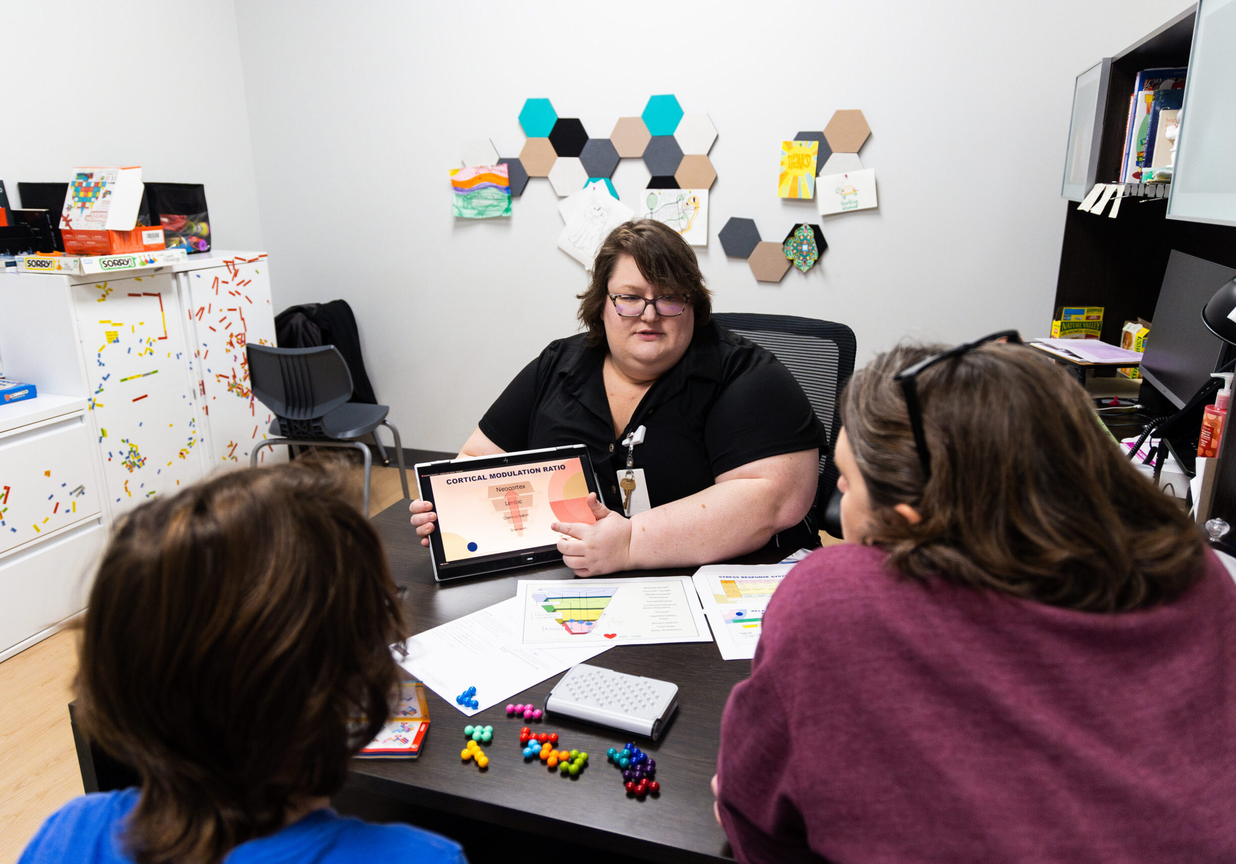 A lady giving talking about assessments to caregivers.