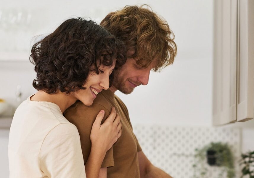 Image of a woman hugging a man in the kitchen