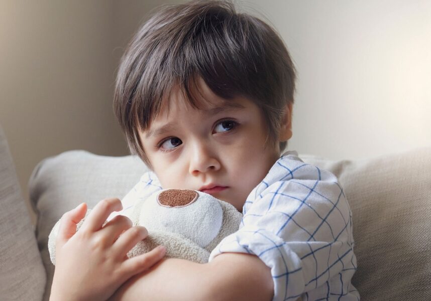 Image of a child upset holding a stuffed animal