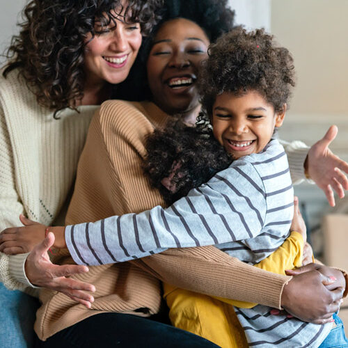 multiethnic women couple having fun with kids at home