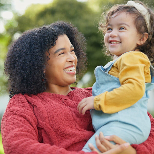 Mom holding daughter in her arms.