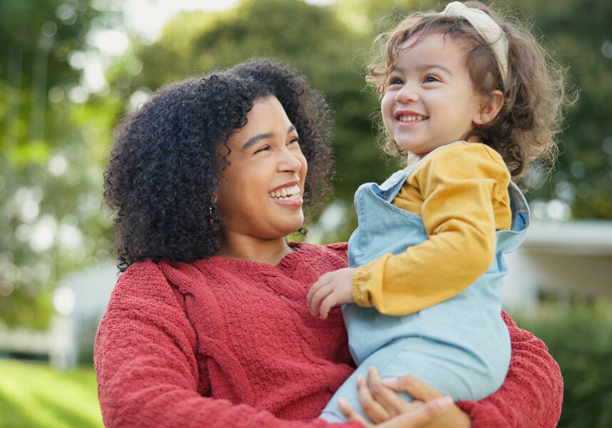 Mom holding daughter in her arms.