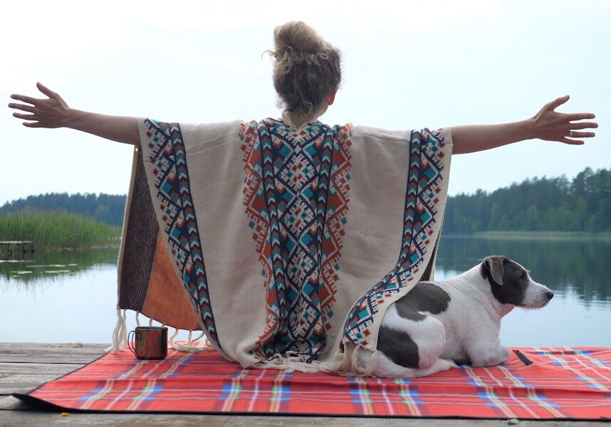 Image of a woman spreading her arms to a lake